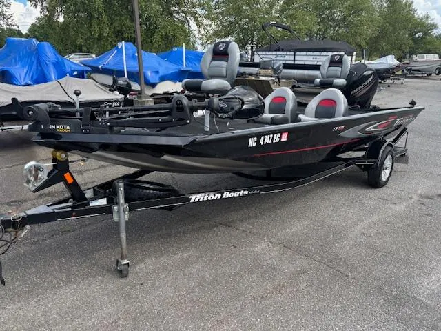 The Image of 2016 Triton 17 CTX fishing boat on trailer, parked outdoors. - 1