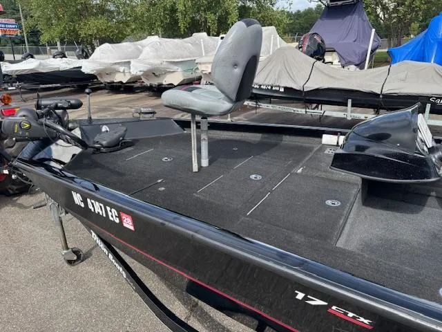 Slide: The Image of 2016 Triton 17 CTX fishing boat with elevated seat, parked outdoors. - 10