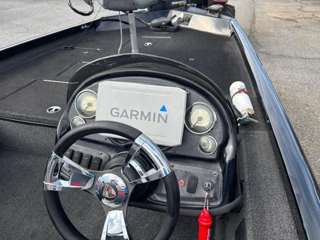 Slide: The Image of 2016 Triton 17 CTX boat dashboard with Garmin navigation system and steering wheel. - 5