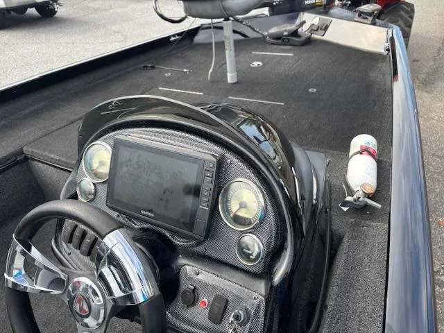 Slide: The Image of 2016 Triton 17 CTX boat dashboard with steering wheel and navigation display. - 6