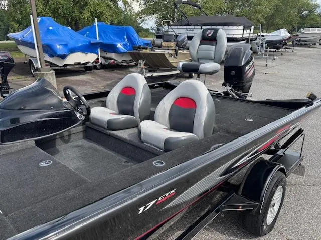 Slide: The Image of 2016 Triton 17 CTX boat with dual seats, parked in a marina. - 11