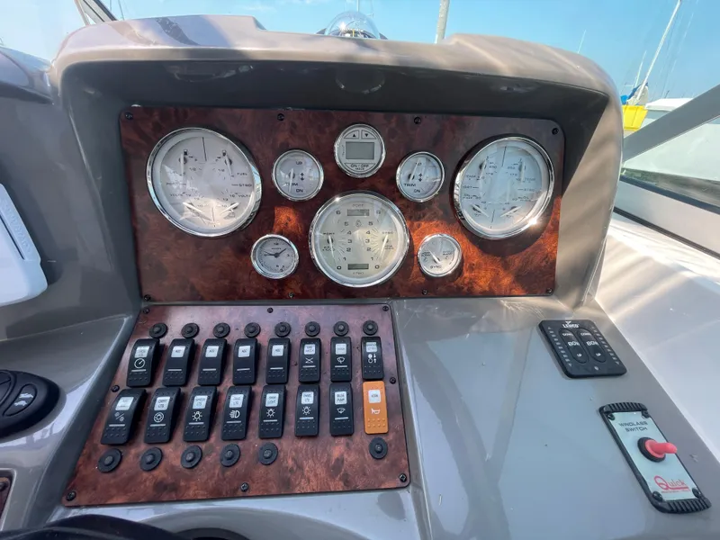 Slide: The Image of Control panel of a 2013 Rinker 310 Express Cruiser with gauges and switches. - 18