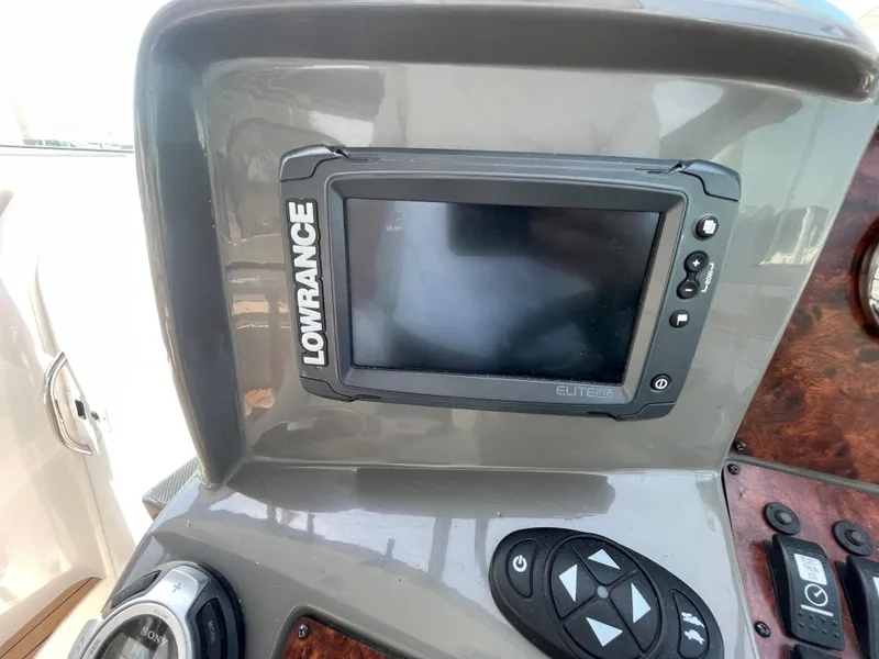 Slide: The Image of Control panel of a 2013 Rinker 310 Express Cruiser with Lowrance Elite-7 HDI display. - 20