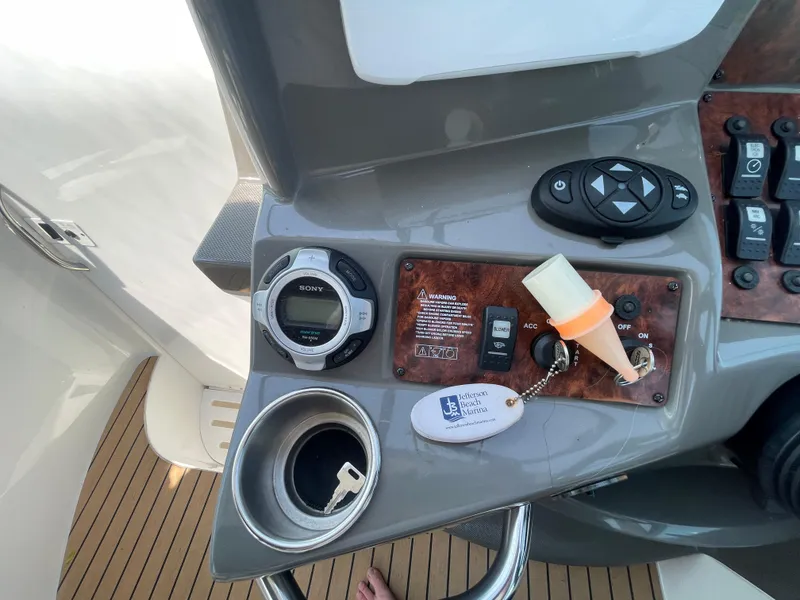 Slide: The Image of Control panel of a 2013 Rinker 310 Express Cruiser with keys and Sony stereo. - 21