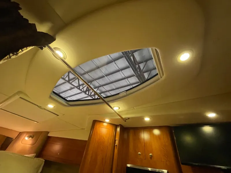 Slide: The Image of Interior view of 2013 Rinker 310 Express Cruiser with skylight and wooden cabinetry. - 29