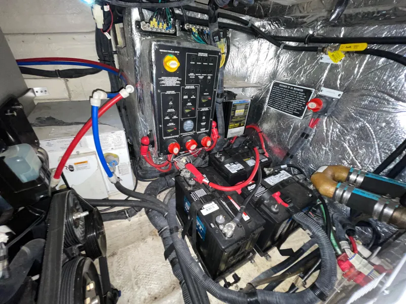 Slide: The Image of Engine compartment of a 2013 Rinker 310 Express Cruiser with batteries and wiring. - 44