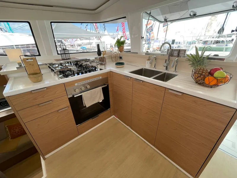 Slide: The Image of Modern kitchen in 2026 Bali 4.4 yacht with wood cabinets and dual sinks. - 13