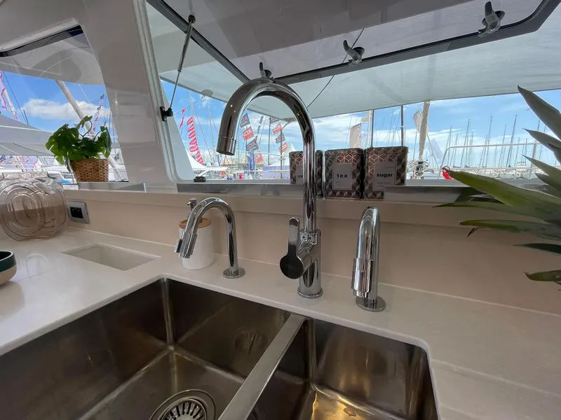 Slide: The Image of Modern kitchen sink on Bali 4.4 yacht, 2026 model, with chrome faucets and marina view. - 15