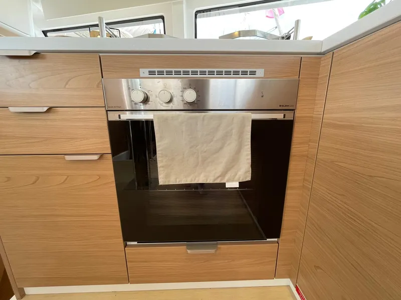 Slide: The Image of Modern kitchen oven with wooden cabinetry, featuring a Bali 4.4 model from 2026. - 18