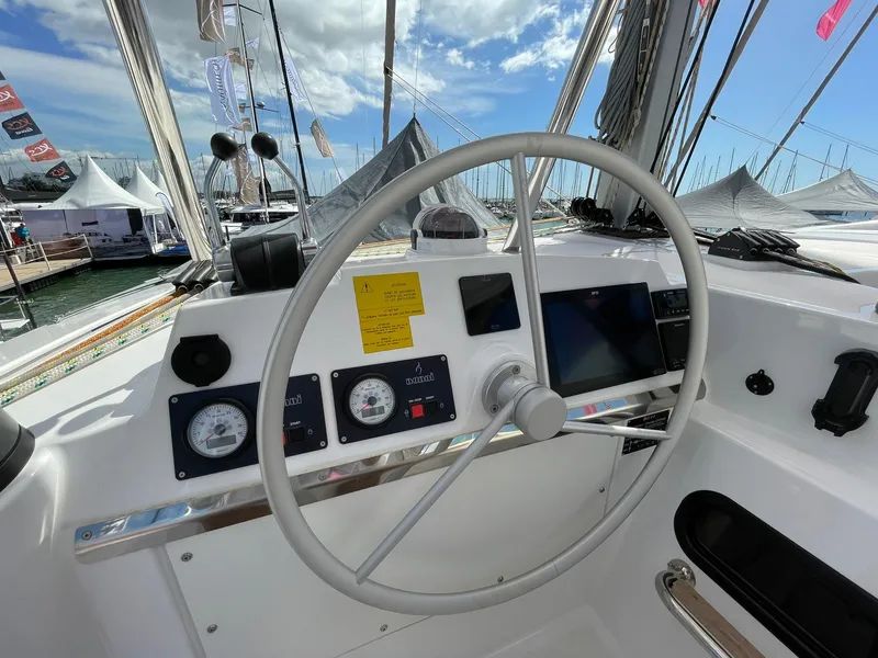 Slide: The Image of Steering wheel of a 2026 Bali 4.4 yacht, featuring modern navigation instruments. - 26