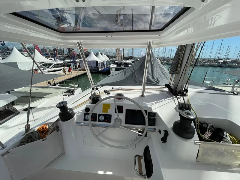 Slide: The Image of Cockpit view of 2026 Bali 4.4 yacht at marina, showcasing steering and controls. - 27