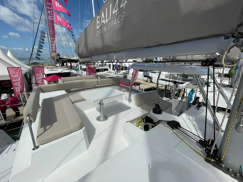 Slide: The Image of Modern Bali 4.4 catamaran deck with seating, showcased at a boat event, 2026 model. - 29