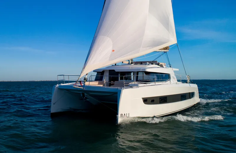 Slide: The Image of Sailing catamaran Bali 4.4, 2026 model, cruising on open sea under clear blue sky. - 36