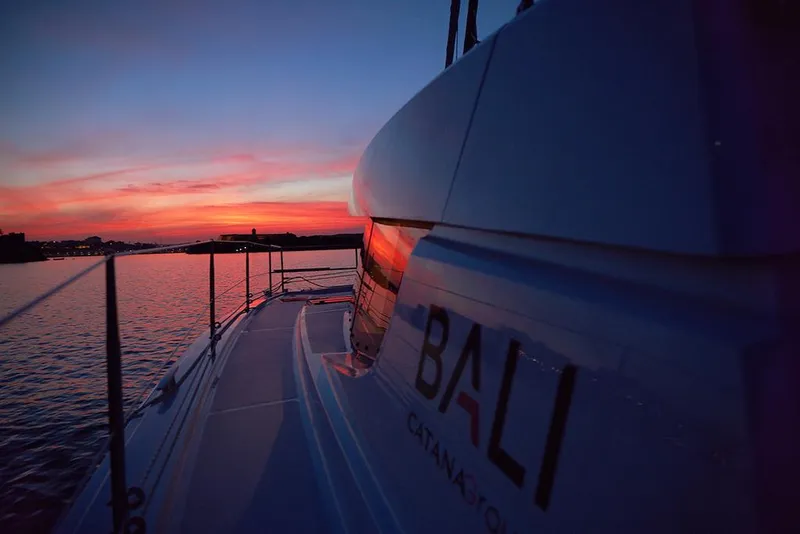 Slide: The Image of Bali 4.4 catamaran at sunset, 2026 model, sailing on calm waters. - 37