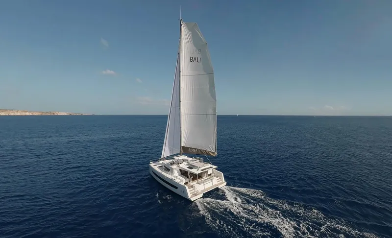 Slide: The Image of Sailing catamaran Bali 4.4, 2026 model, cruising on open sea under clear skies. - 42