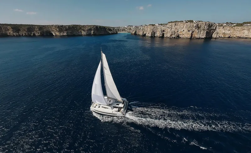 Slide: The Image of Sailing yacht Bali 4.4 (2026) navigating through scenic coastal waters. - 43