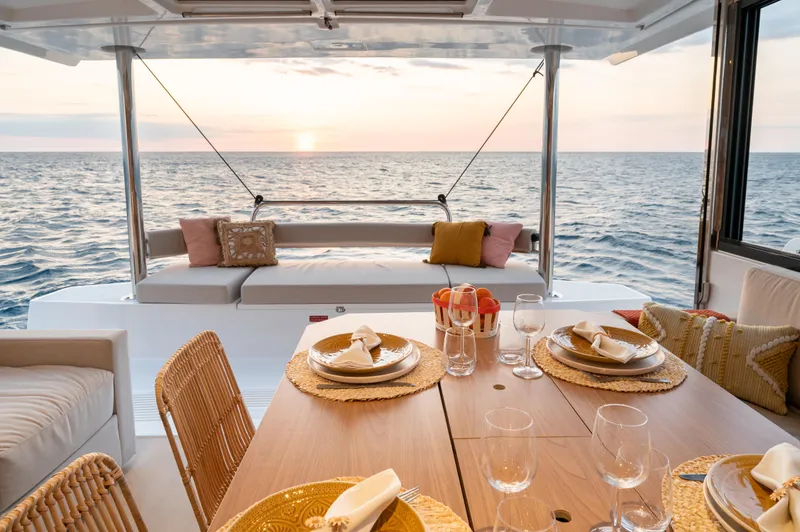 Slide: The Image of Luxurious Bali 4.4 yacht dining area with ocean view, set for sunset dinner, 2026 model. - 6