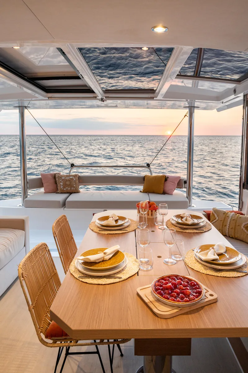 Slide: The Image of Luxurious Bali 4.4 yacht dining area with ocean view at sunset, 2026 model. - 7
