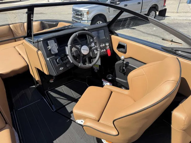 Slide: The Image of 2025 Moomba Tykon boat interior with tan leather seats and modern dashboard. - 12