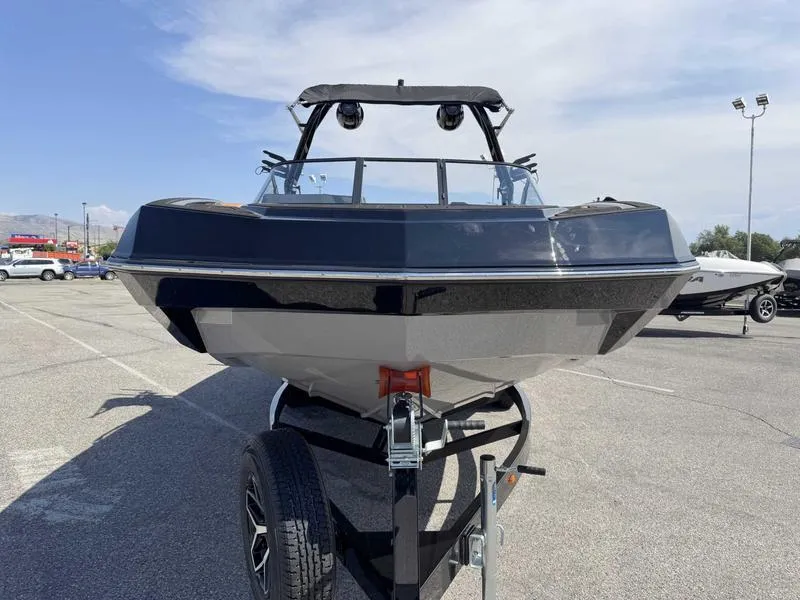 Slide: The Image of 2025 Moomba Tykon boat on trailer in parking lot, front view. - 13