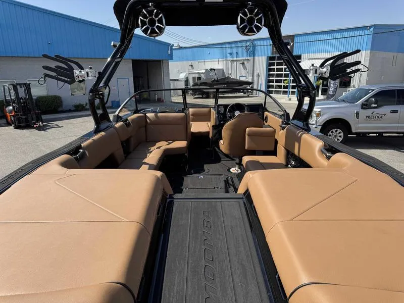Slide: The Image of 2025 Moomba Tykon boat interior with tan seating, black accents, and modern design. - 14