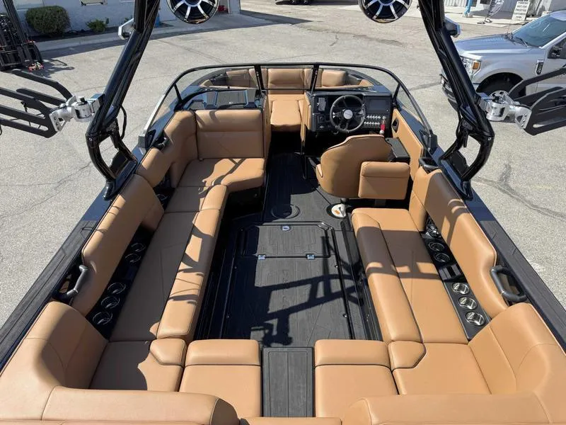 Slide: The Image of 2025 Moomba Tykon boat interior with tan seating and modern dashboard. - 5