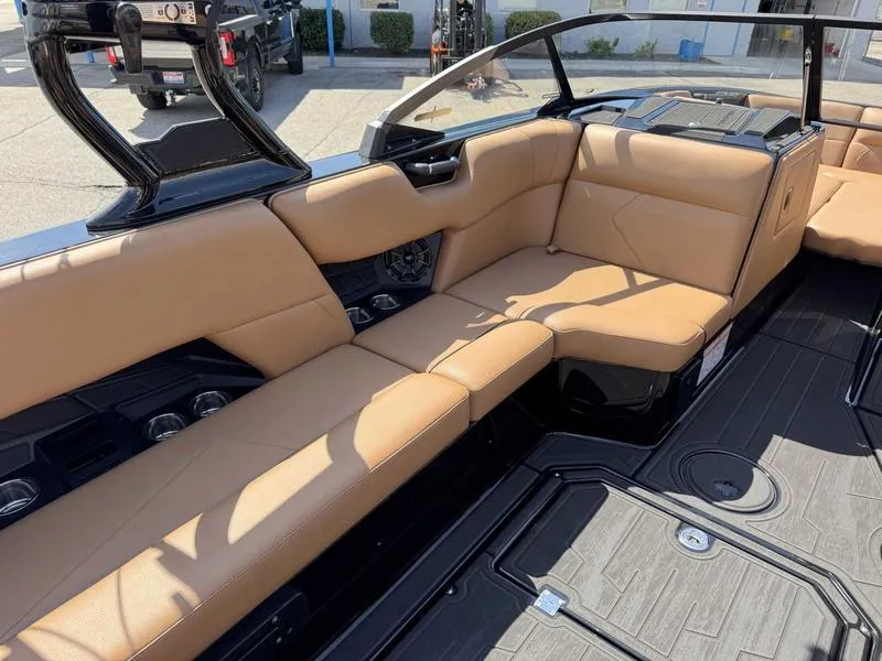 Slide: The Image of 2025 Moomba Tykon boat interior with tan leather seating and modern design. - 9