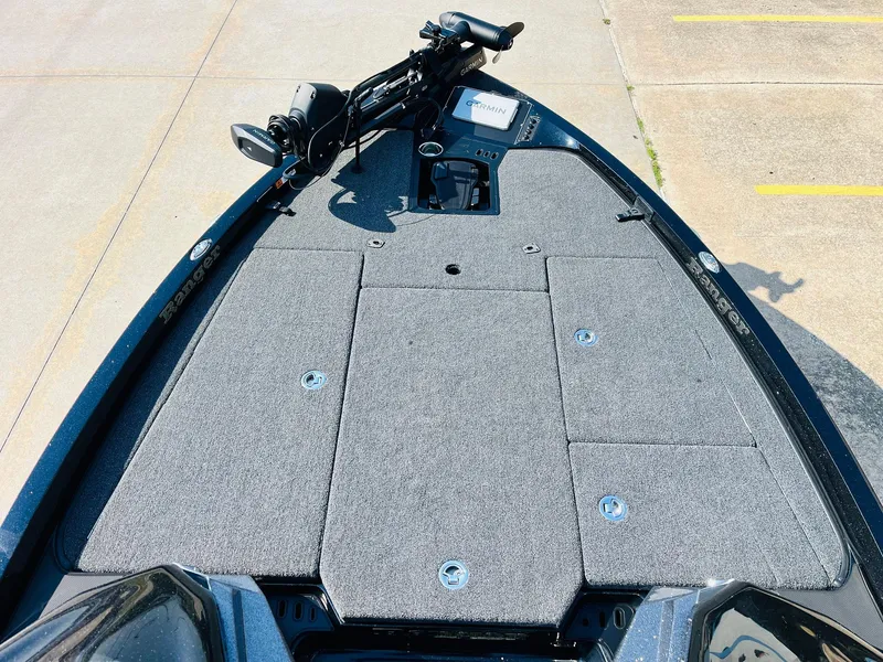 Slide: The Image of 2025 Ranger Z518 Cup-Equipped boat deck with Garmin system and carpeted surface. - 12