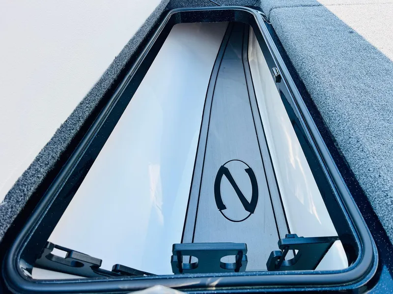 Slide: The Image of 2025 Ranger Z518 Cup-Equipped boat storage compartment with sleek design and logo detail. - 18
