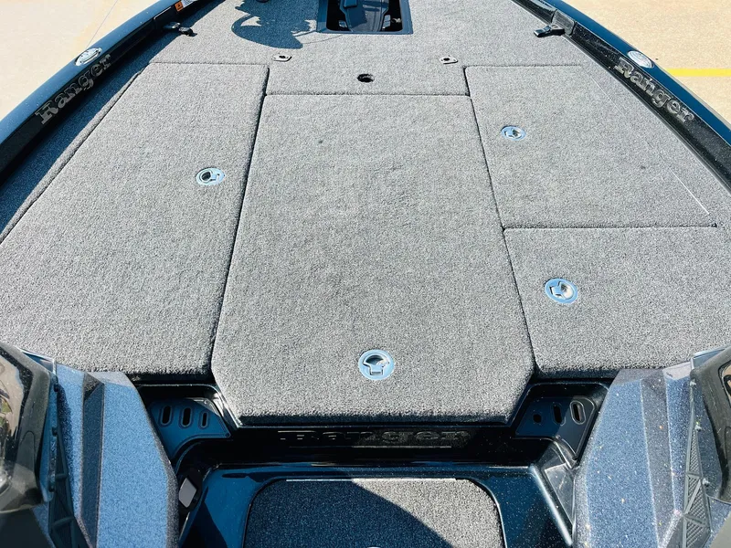 Slide: The Image of 2025 Ranger Z518 Cup-Equipped boat deck with carpeted surface and storage compartments. - 19