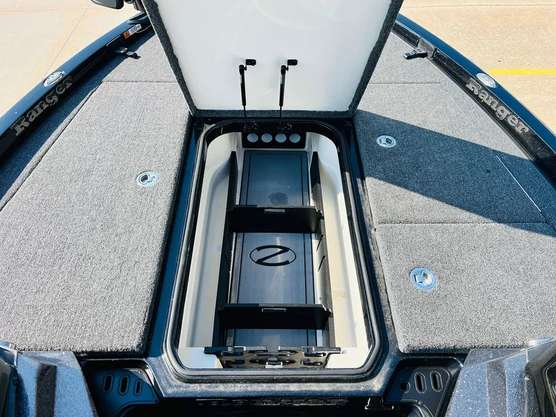 Slide: The Image of 2025 Ranger Z518 Cup-Equipped boat storage compartment with open lid, showcasing interior design. - 20
