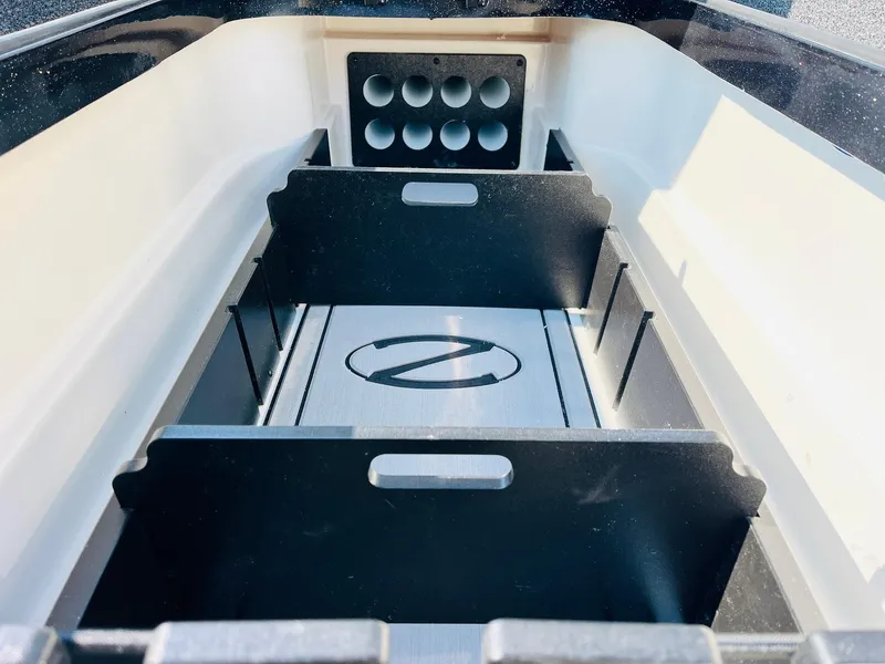 Slide: The Image of 2025 Ranger Z518 Cup-Equipped boat storage compartment with organized slots and sleek design. - 21
