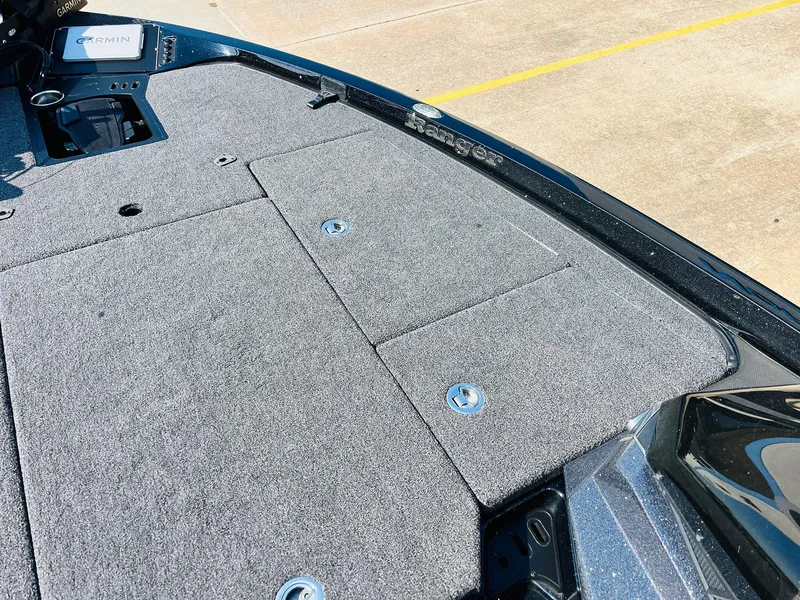 Slide: The Image of 2025 Ranger Z518 Cup-Equipped boat deck with carpeted surface and storage compartments. - 22