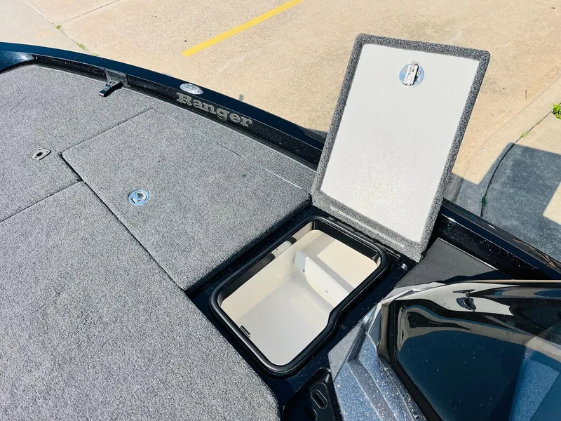 Slide: The Image of 2025 Ranger Z518 Cup-Equipped boat storage compartment with open hatch, showcasing interior space. - 25