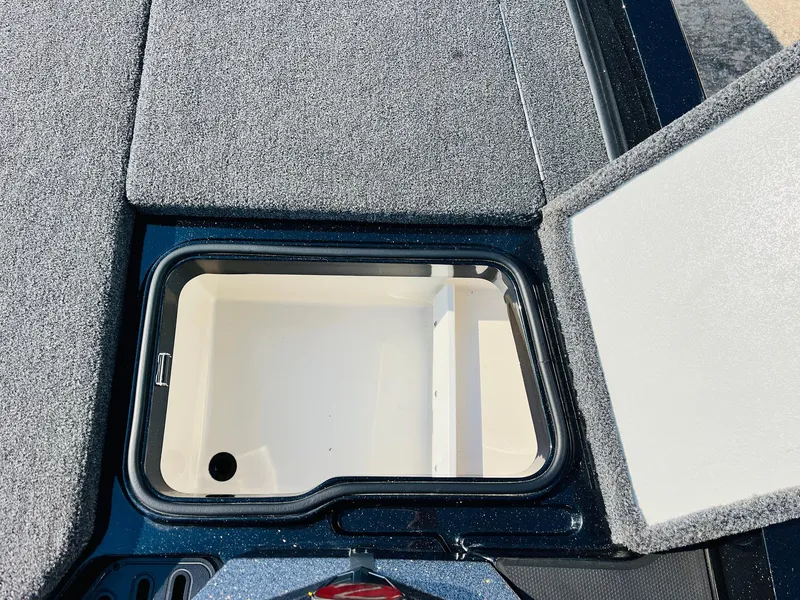 Slide: The Image of Open storage compartment on 2025 Ranger Z518 Cup-Equipped boat deck. - 26