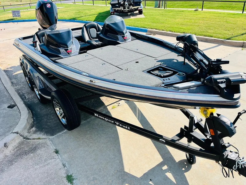 Slide: The Image of 2025 Ranger Z518 Cup-Equipped boat on trailer, parked on concrete, with green grass in background. - 3