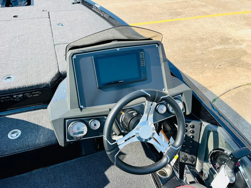 Slide: The Image of 2025 Ranger Z518 Cup-Equipped boat dashboard with steering wheel and digital display. - 36