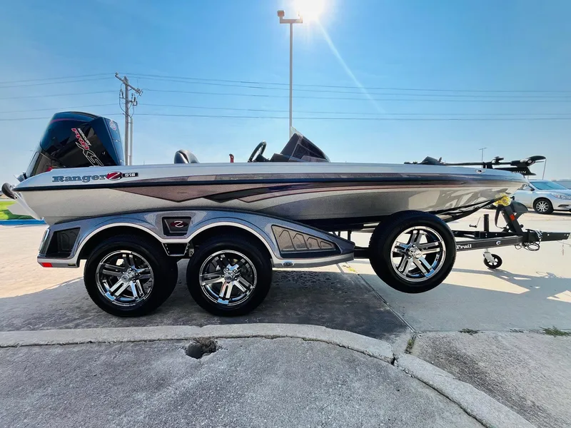 Slide: The Image of 2025 Ranger Z518 Cup-Equipped boat on trailer, sleek design, shiny chrome wheels, sunny day. - 4