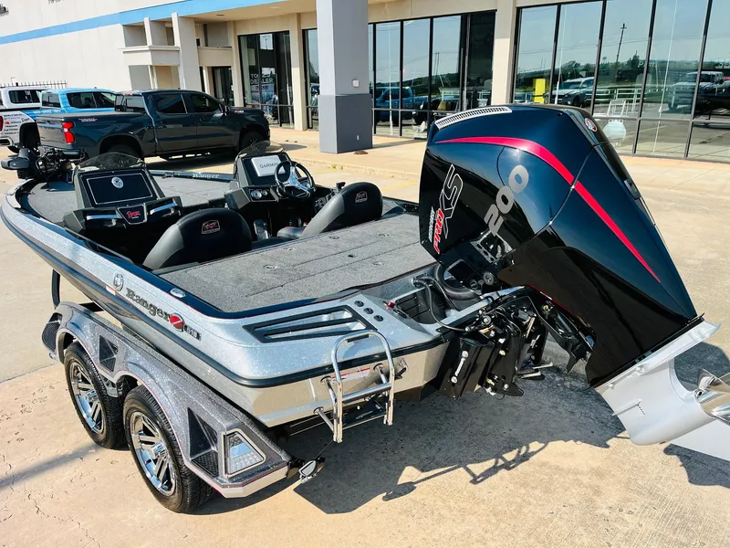 Slide: The Image of 2025 Ranger Z518 Cup-Equipped boat with powerful outboard motor, parked outdoors. - 7