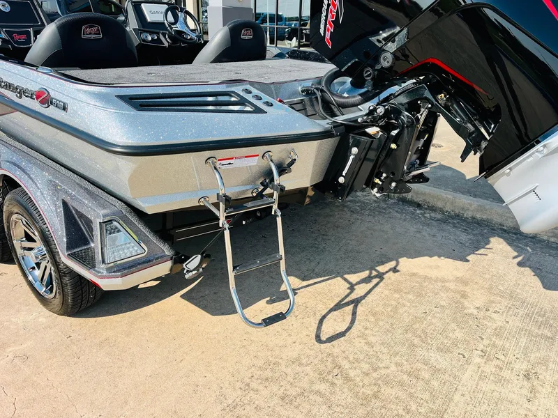 Slide: The Image of 2025 Ranger Z518 Cup-Equipped boat with ladder and motor, parked on concrete. - 9