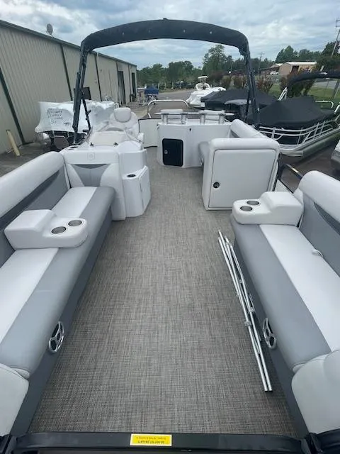 Slide: The Image of Pontoon boat interior with gray seating, Sweetwater 2286, 2016 model, docked outdoors. - 10