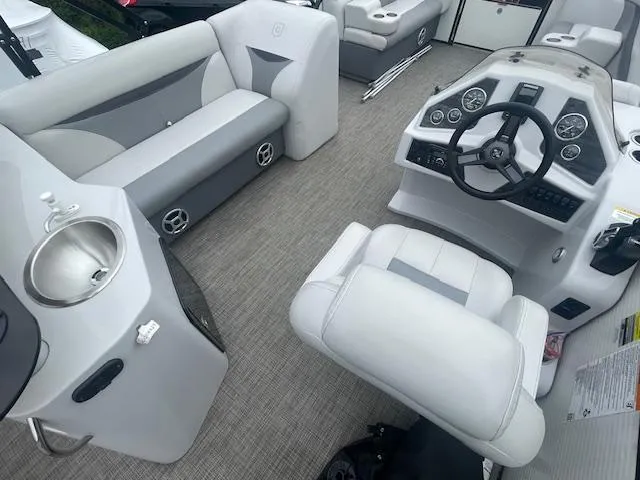 Slide: The Image of Interior of 2016 Sweetwater 2286 pontoon boat with gray seating and modern dashboard. - 11