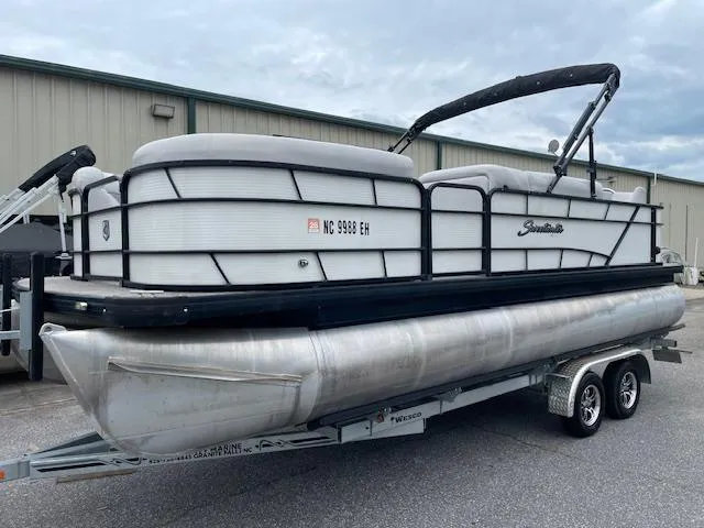 Slide: The Image of 2016 Sweetwater 2286 pontoon boat on trailer, parked outdoors. - 13