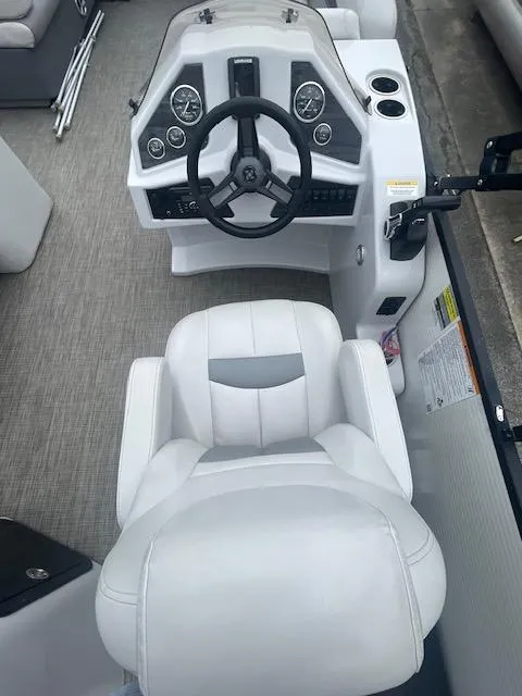 Slide: The Image of Captain's seat and helm of 2016 Sweetwater 2286 boat, featuring modern controls and steering wheel. - 6