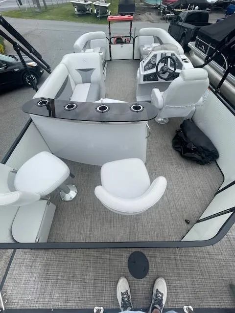 Slide: The Image of Interior of a 2016 Sweetwater 2286 pontoon boat with white seating and helm. - 7