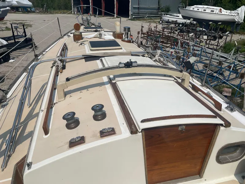 Slide: The Image of 1980 Cape Dory 36 sailboat deck view in a boatyard setting. - 11