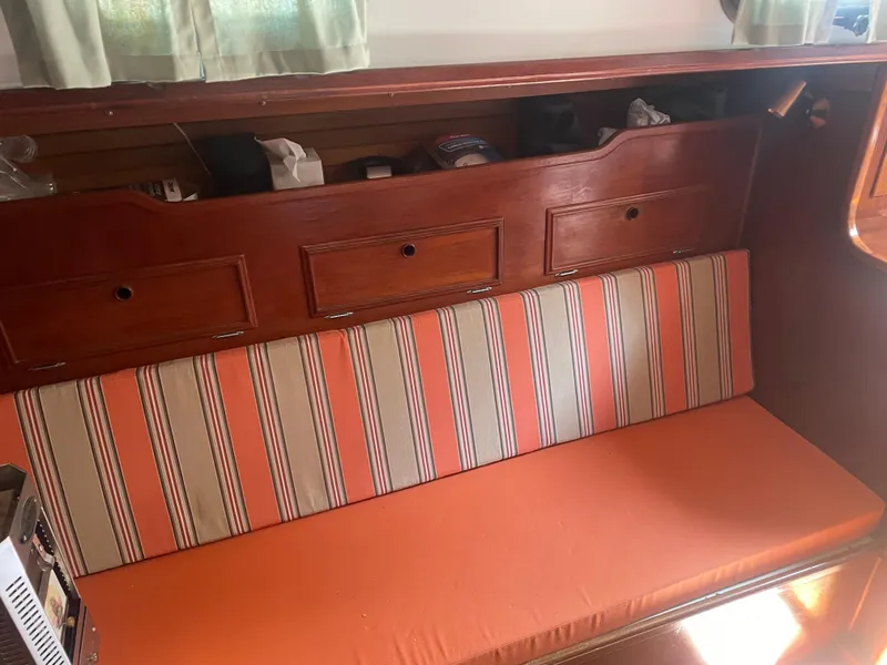 Slide: The Image of Interior of 1980 Cape Dory 36 sailboat with striped cushions and wooden storage cabinets. - 17