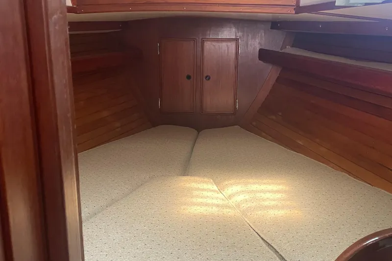 Slide: The Image of Interior cabin of 1980 Cape Dory 36 sailboat with wooden finish and cozy bedding. - 19