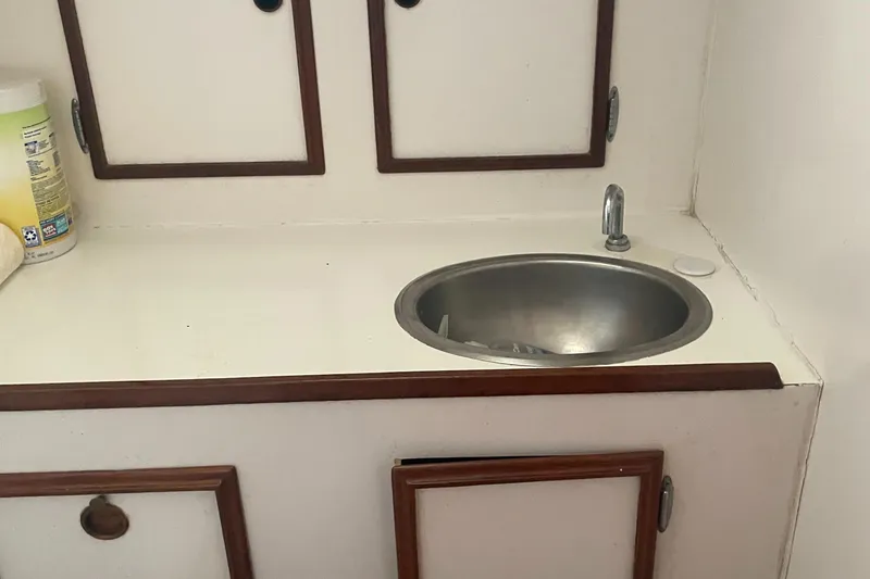 Slide: The Image of Compact sink area in 1980 Cape Dory 36 yacht with wooden cabinetry. - 20