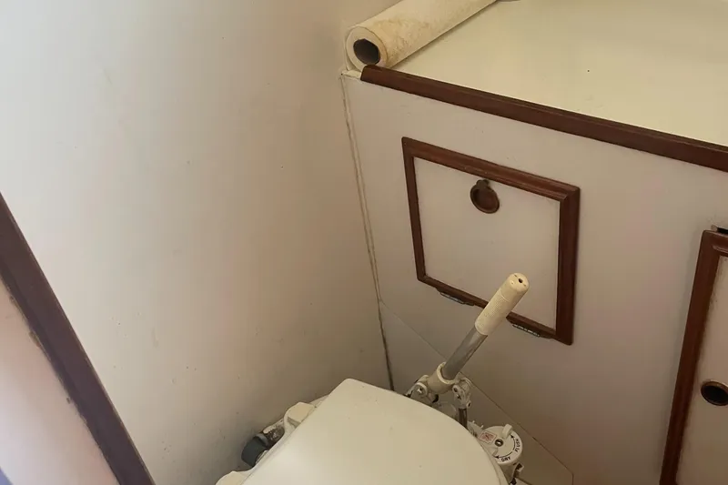 Slide: The Image of Interior of 1980 Cape Dory 36 sailboat bathroom with toilet and storage cabinet. - 21